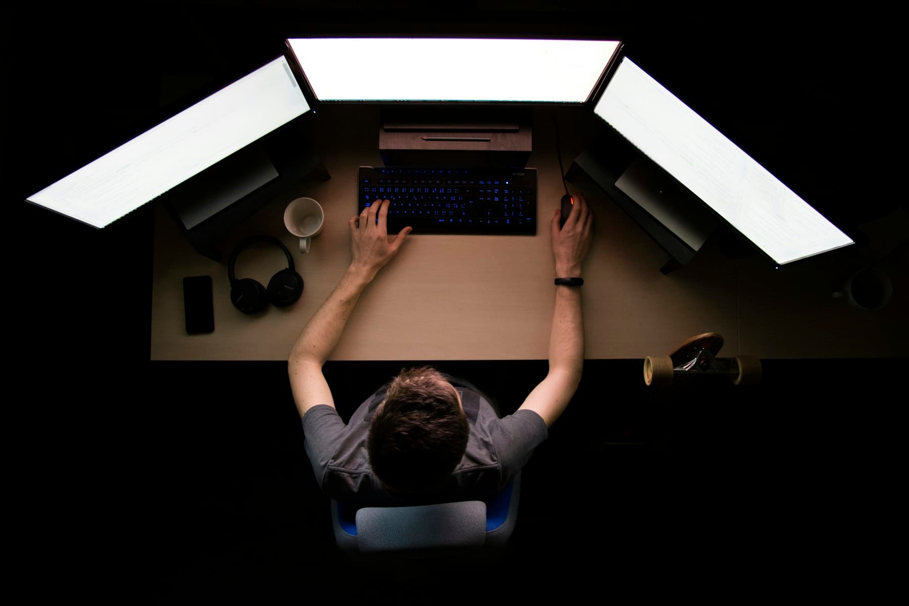 A person working at a desk in a dark room