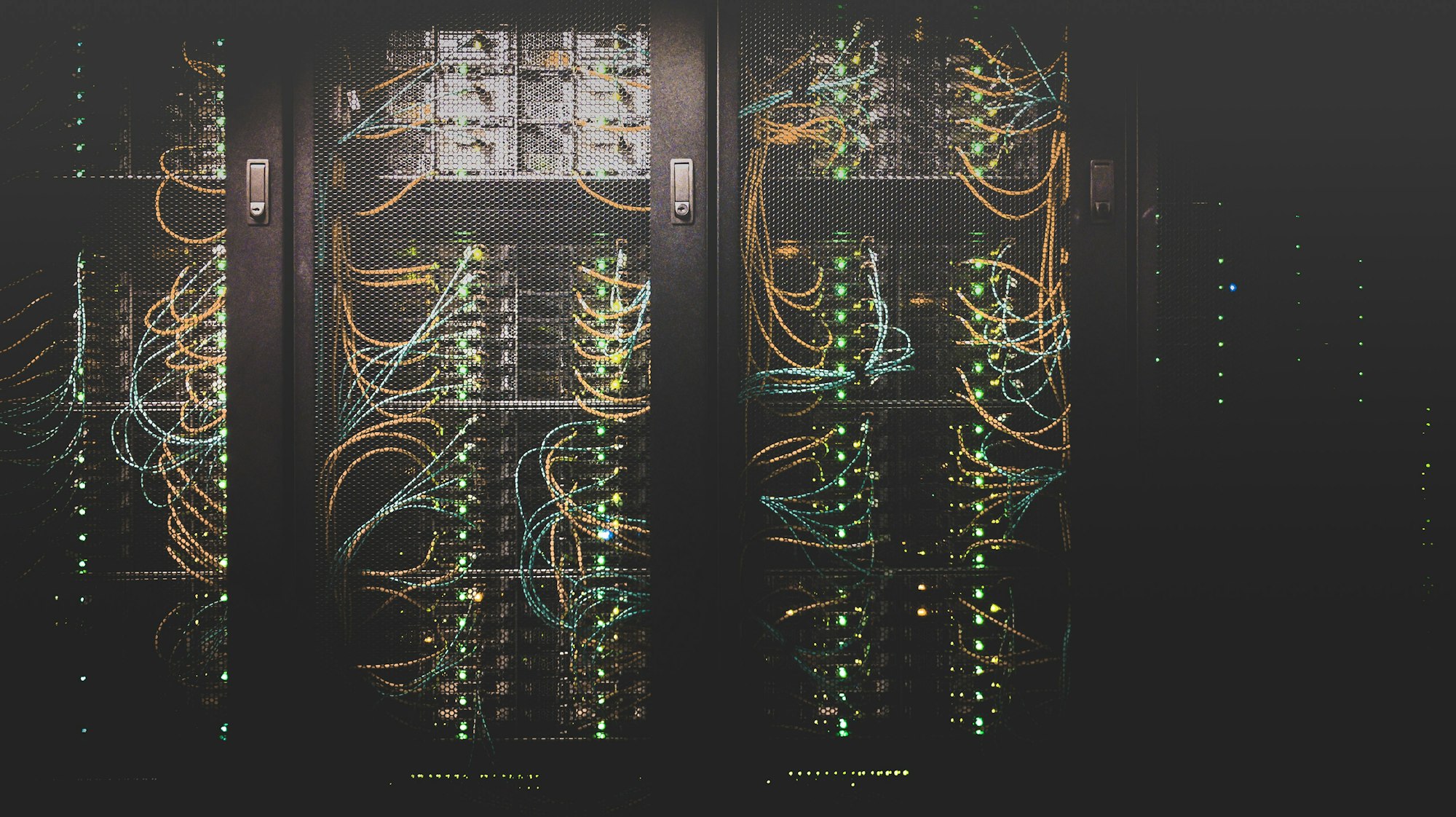 Server racks lit in a dark room